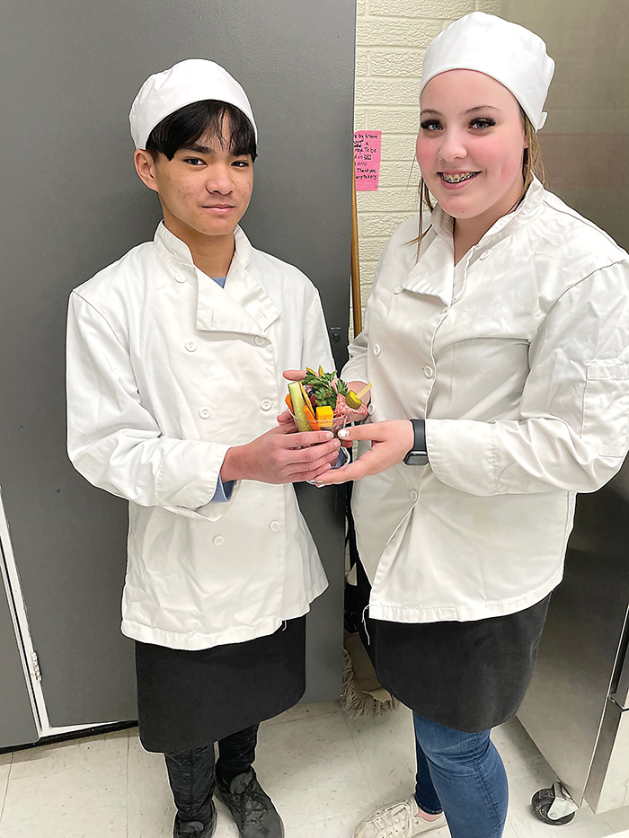 Kennedi and Charlton of McNaughton High School share one of the healthy breakfast recipes that their Home Ec. class makes for their breakfast program at the school. 